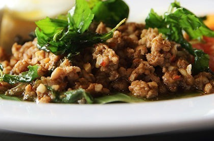 fried pork mince served with green leaves